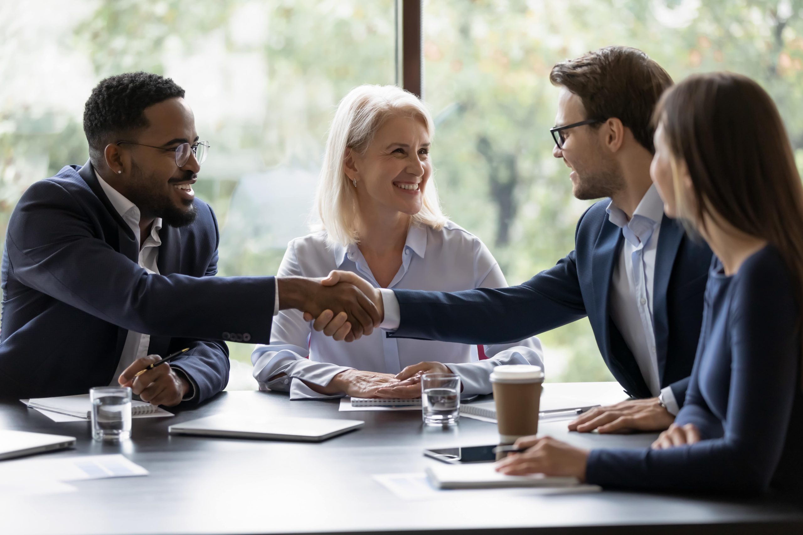 Diverse Business Team Shaking Hands at meeting